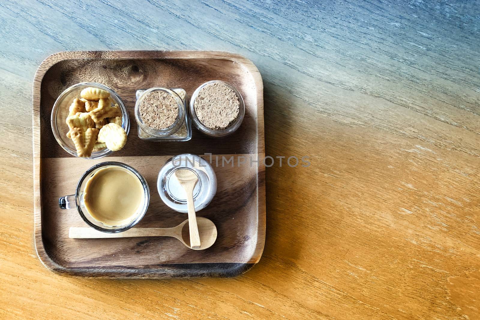 Espresso coffee and cracker on wooden table background