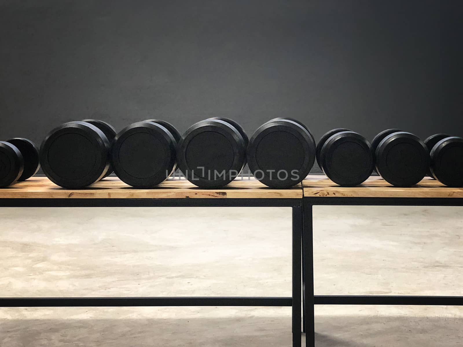 Black dumbbell set. Close up many metal dumbbells in sport fitness center 