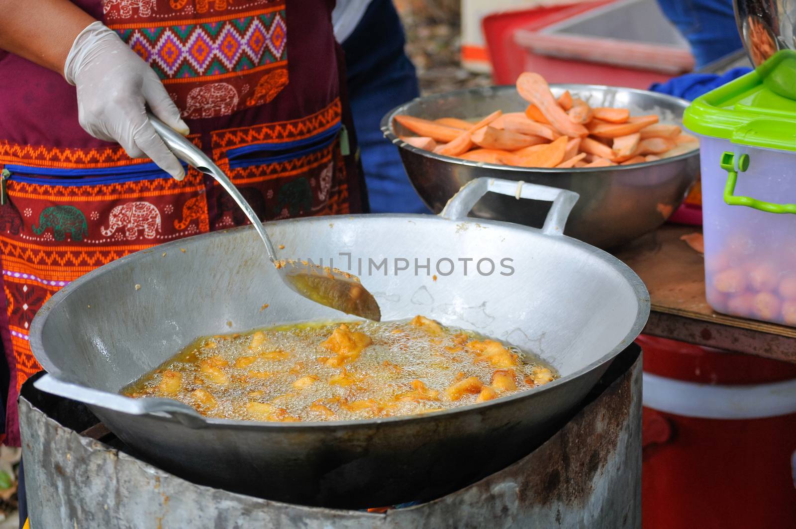 Sweet Potatoes being fried in Frying Pan with Heat Palm Oil by thampapon