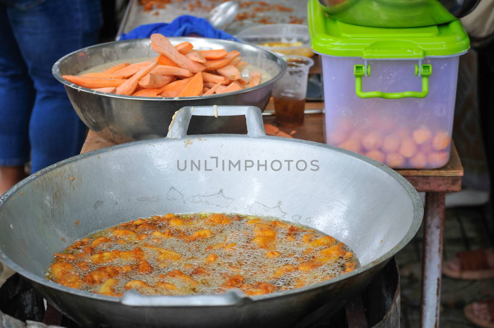 Sweet Potatoes being fried in Frying Pan with Heat Palm Oil by thampapon