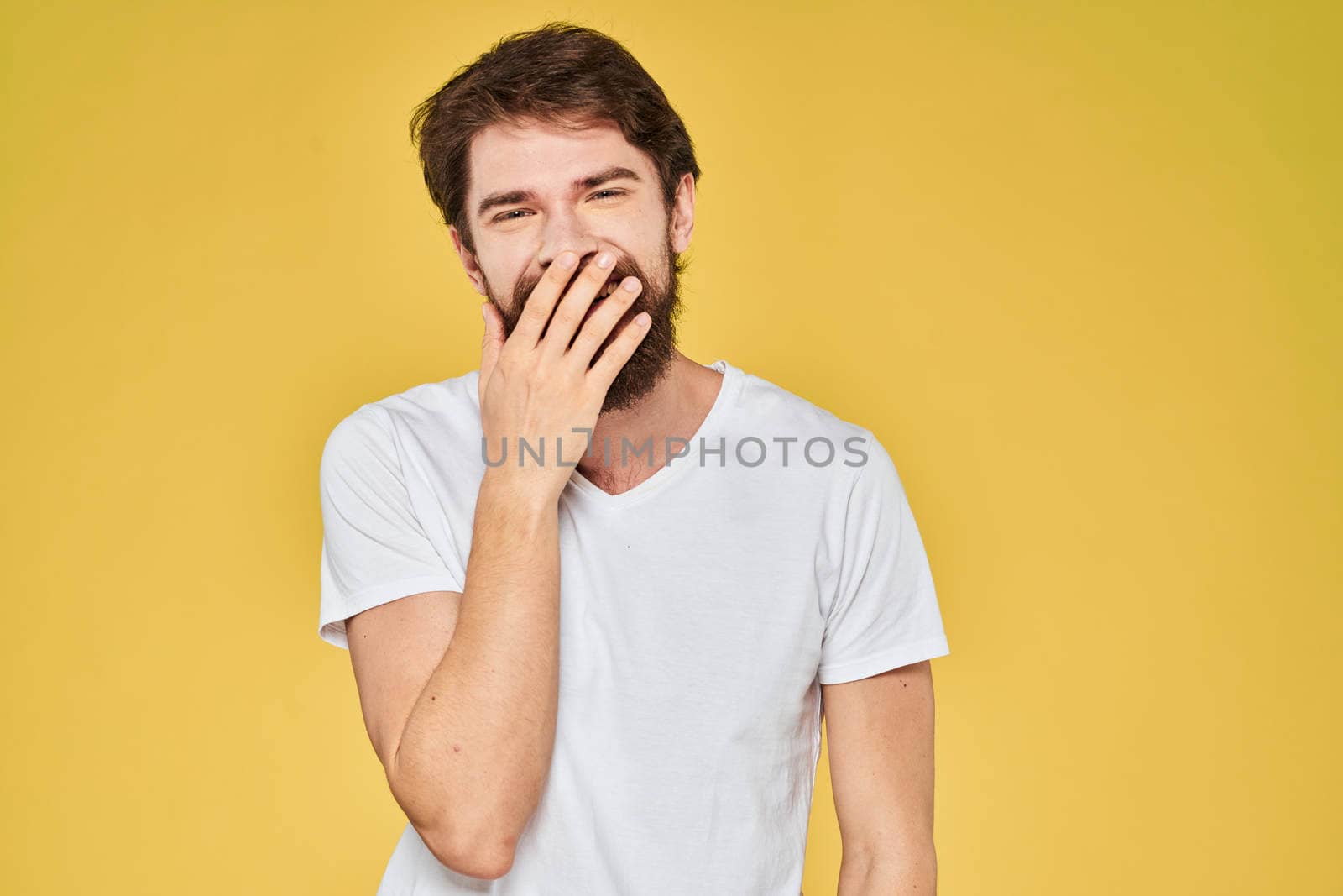 Bearded man on emotions white t-shirt fun lifestyle yellow background by SHOTPRIME