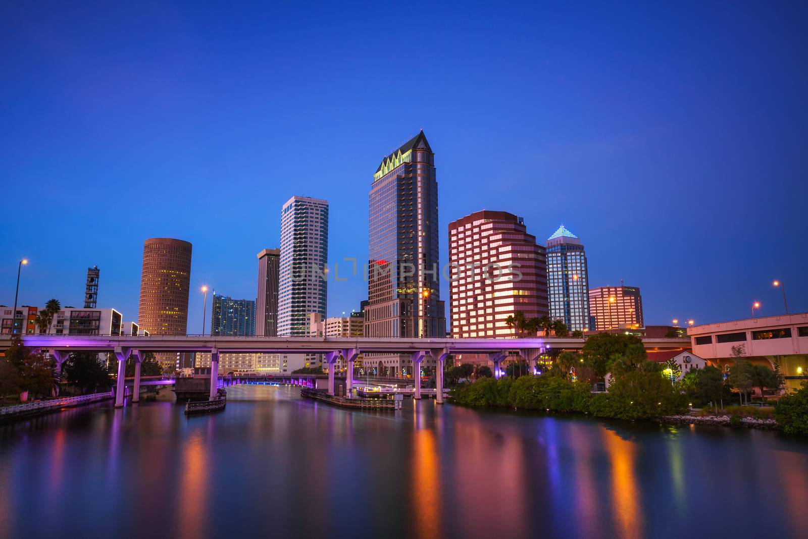 The skyline of downtown Tampa after sunset with Hillsborough river in the foreground. Long exposure.