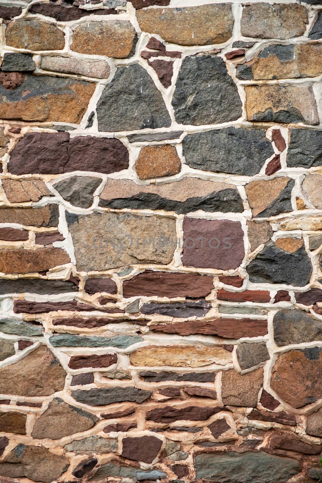 Beautiful vertical image of a colonial American stone wall. Beautiful natural pattern background.