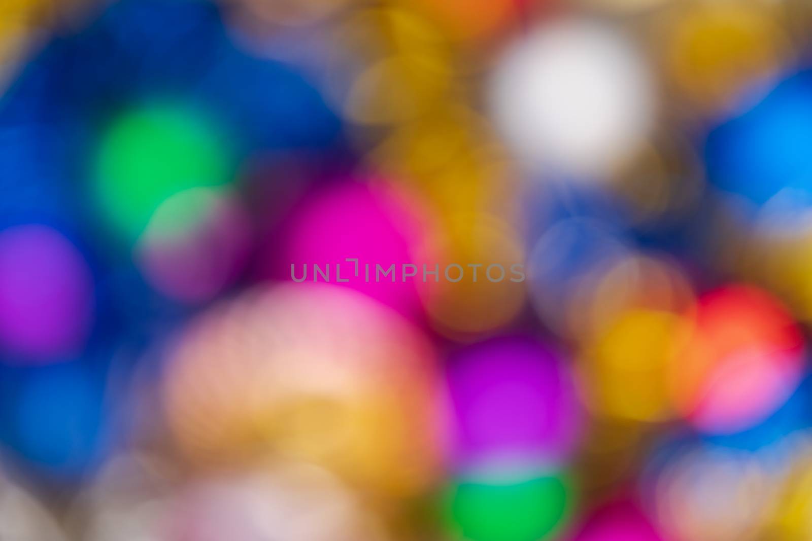 Defocused beautiful Happy New Year holiday decorations, abstract blurry bokeh background effect. Out of focus glowing lights celebration texture for use at graphic design.