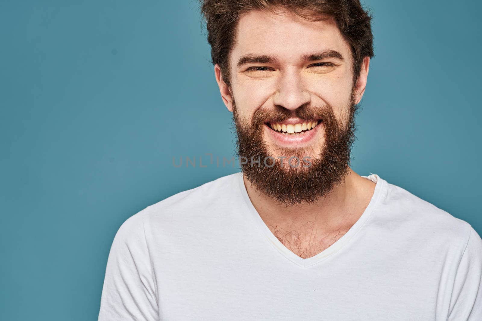 emotional man gesturing with hands lifestyle fun white t-shirt blue isolated stock. High quality photo