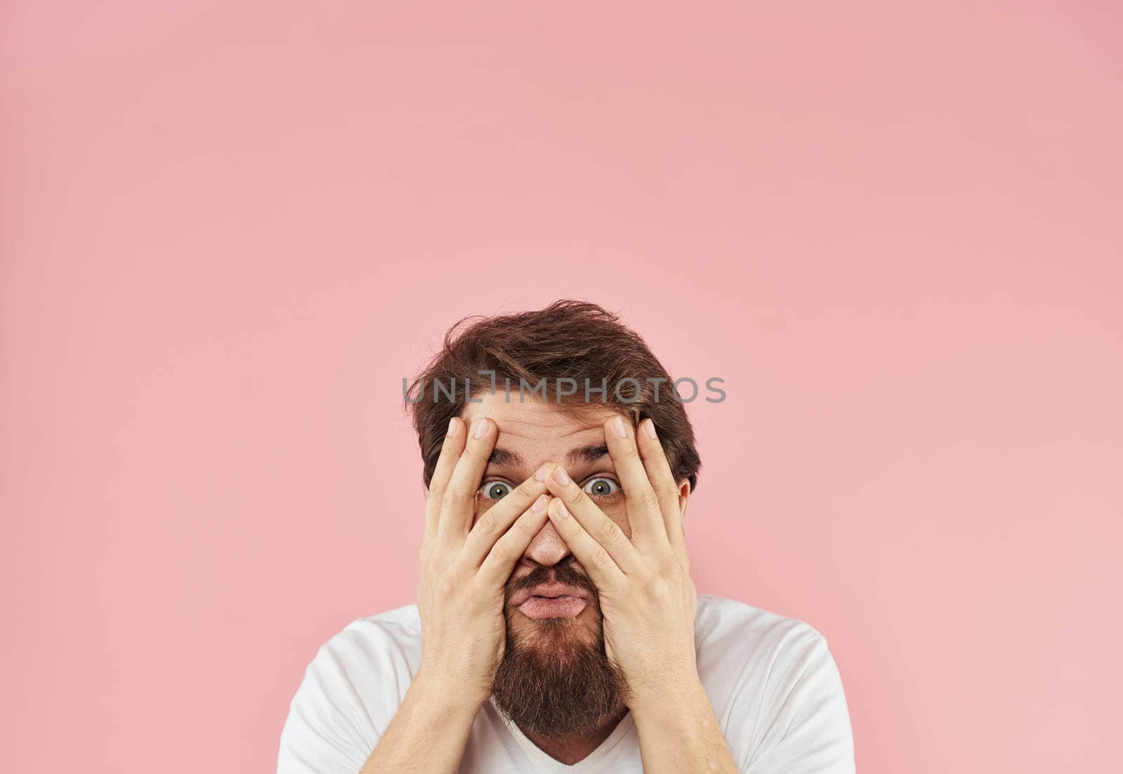 guy touches his head with his hands emotions and stress Model shock. High quality photo