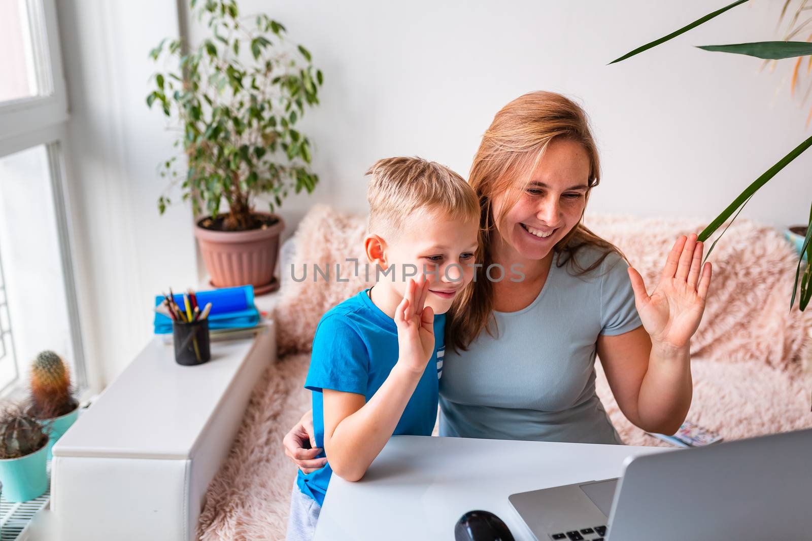 Mother with kid trying to work from home during quarantine. Stay at home, work from home concept during coronavirus pandemic