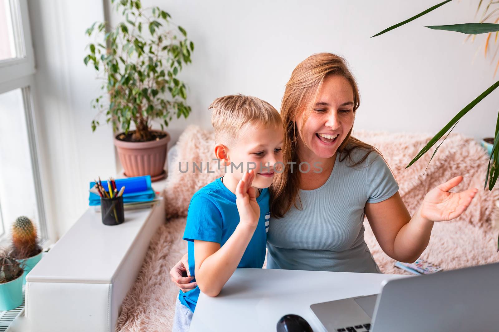 Mother with kid trying to work from home during quarantine. Stay at home, work from home concept during coronavirus pandemic