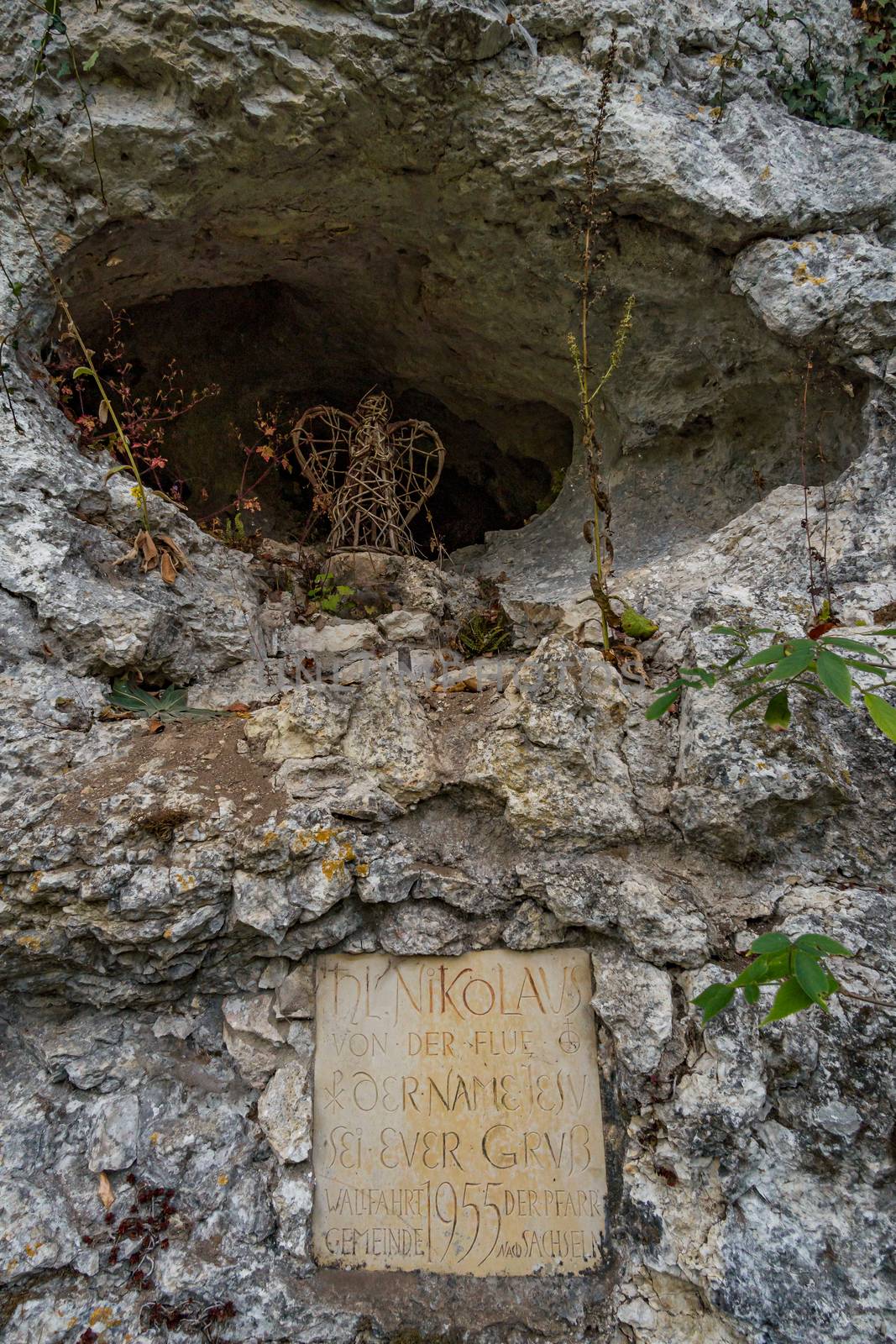 Holy stone statue in the Brother Klaus grotto at Beuron Monastery in the Danube Valley in autumn by mindscapephotos