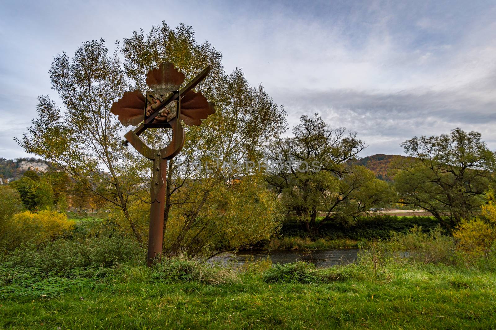 Holy stone statue in the Brother Klaus grotto at Beuron Monastery in the Danube Valley in autumn by mindscapephotos