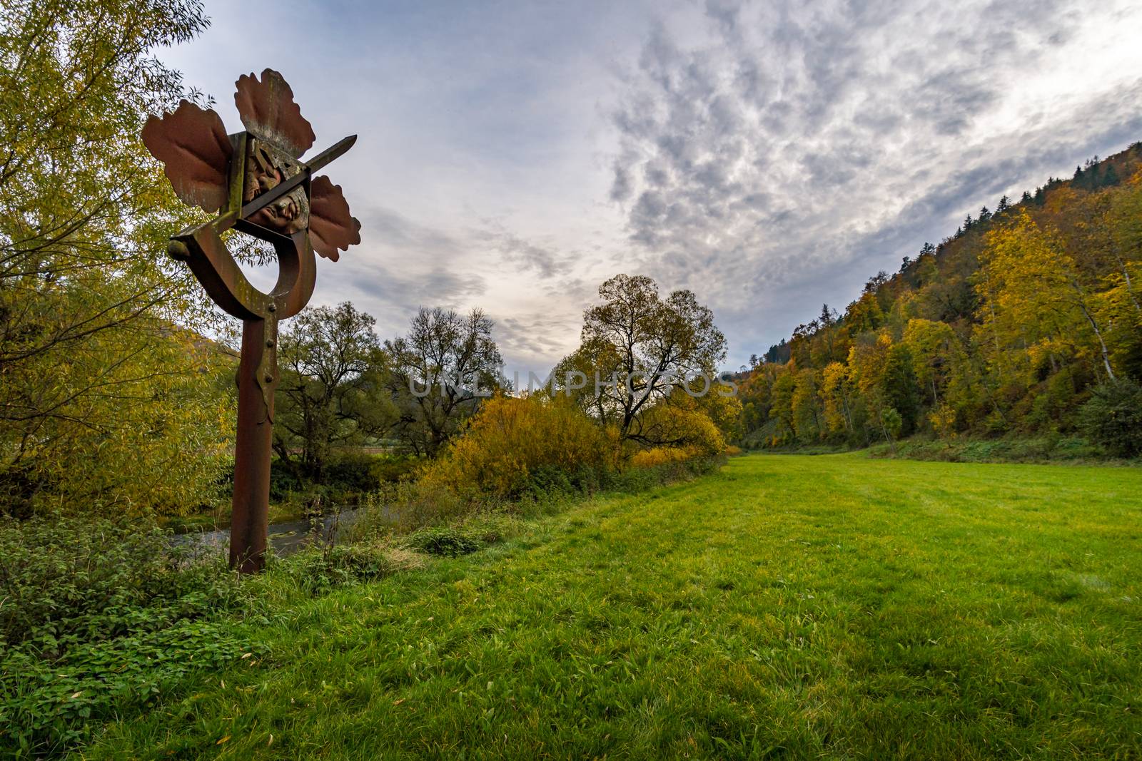 Holy stone statue in the Brother Klaus grotto at Beuron Monastery in the Danube Valley in autumn by mindscapephotos