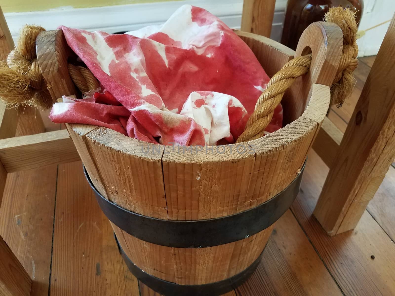 wood bucket or pail with bloody rags or cloths