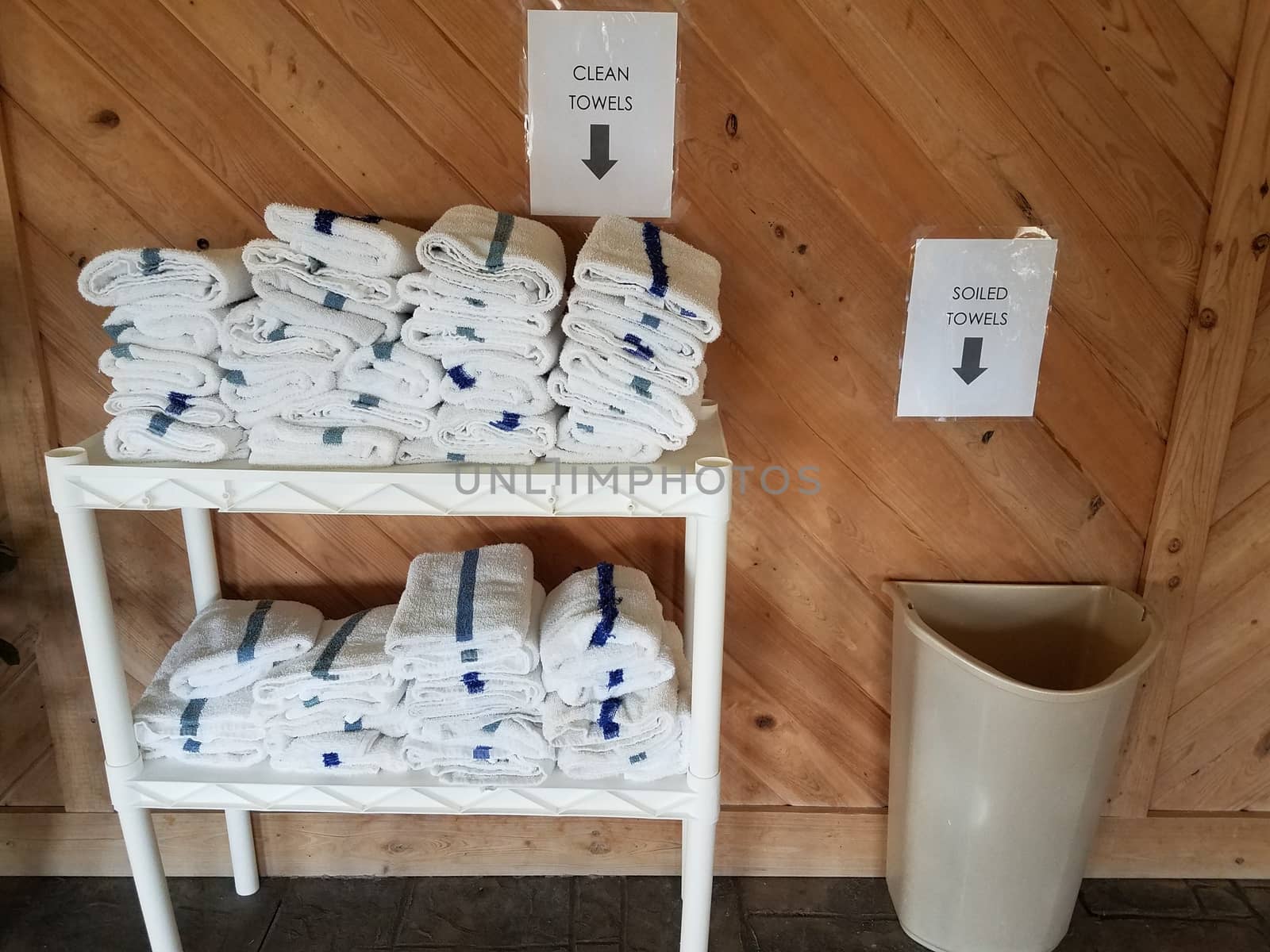 clean and soiled or dirty towels on shelf near swimming pool