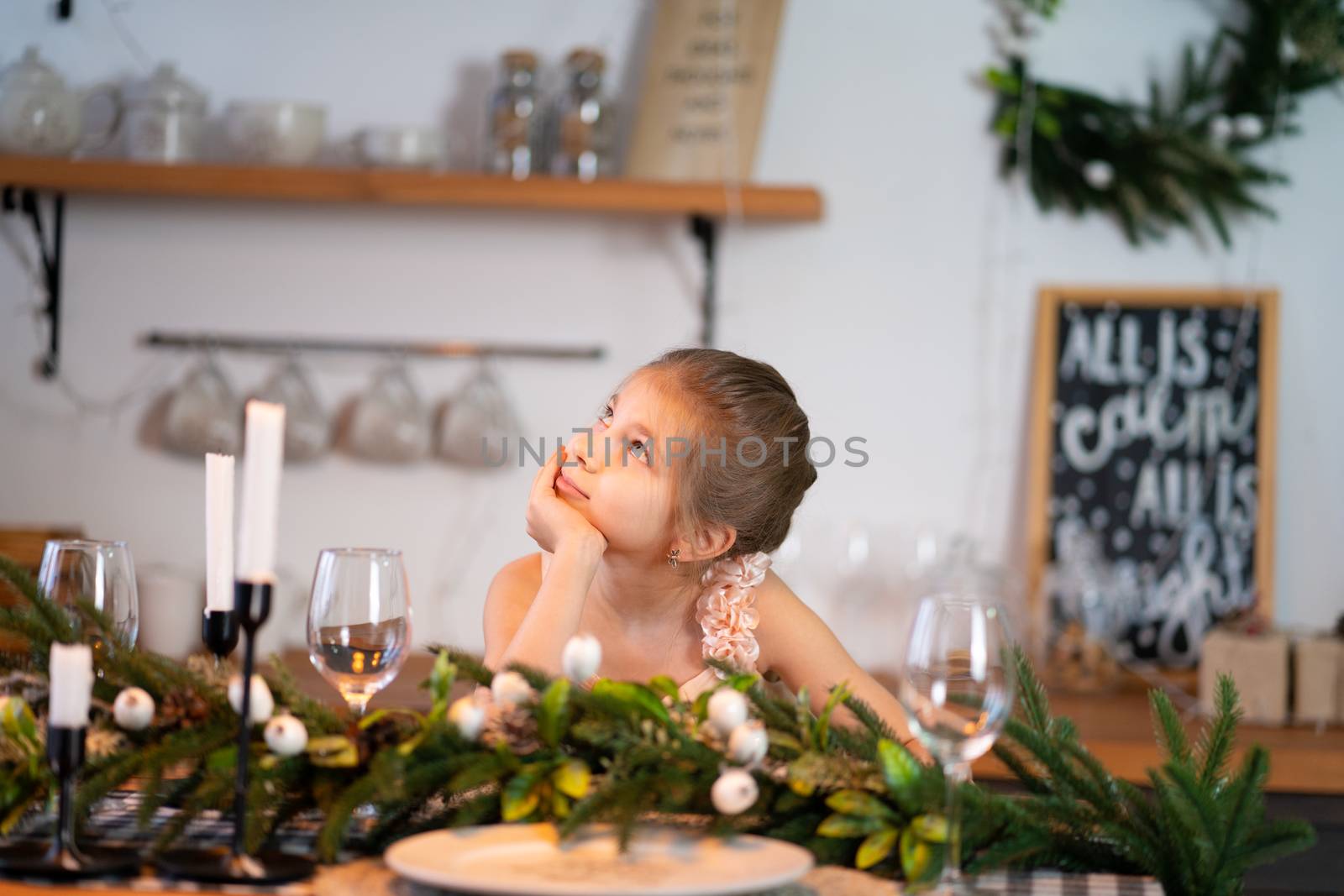 Little girl is bored sitting at the festive table on Christmas night by Try_my_best