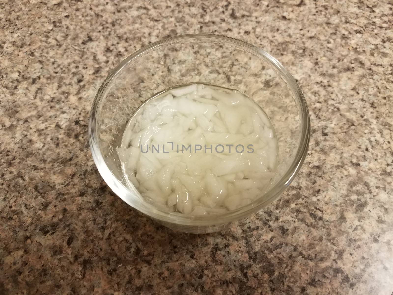 chopped onions and liquid in glass container by stockphotofan1