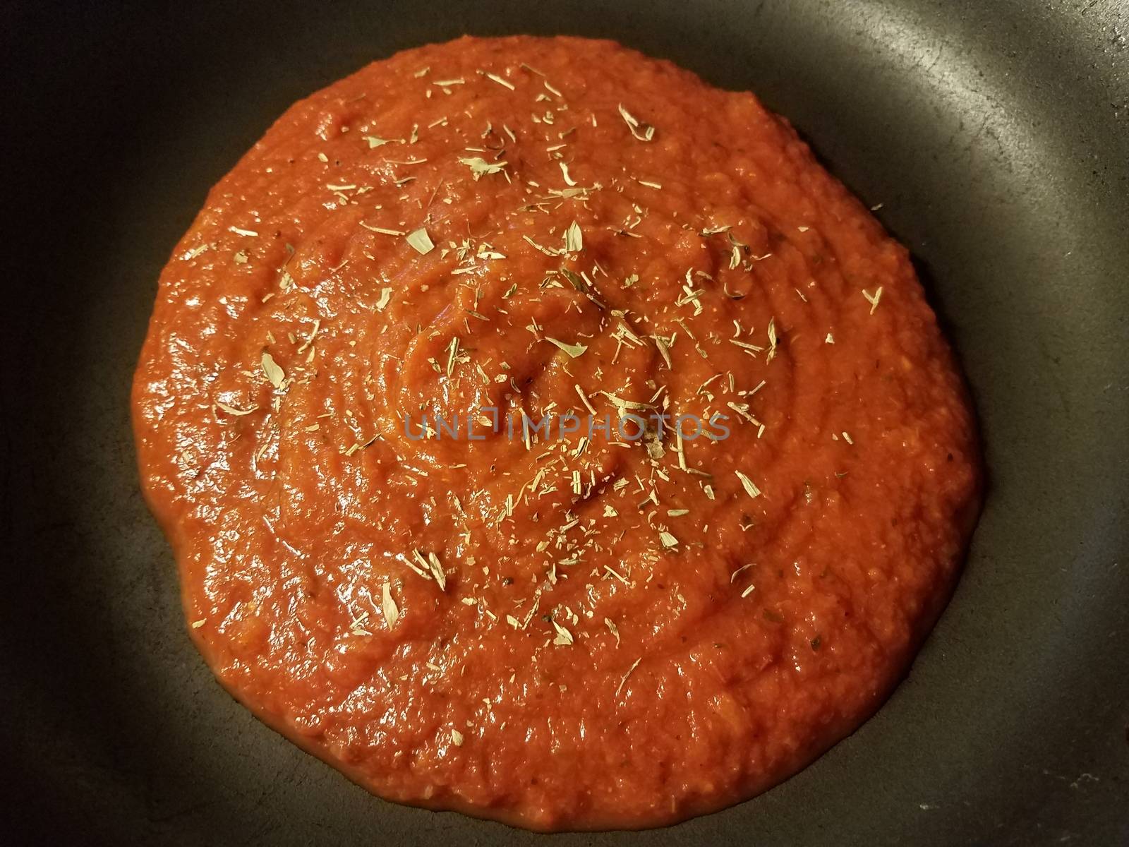 red tomato sauce in frying pan or skillet by stockphotofan1