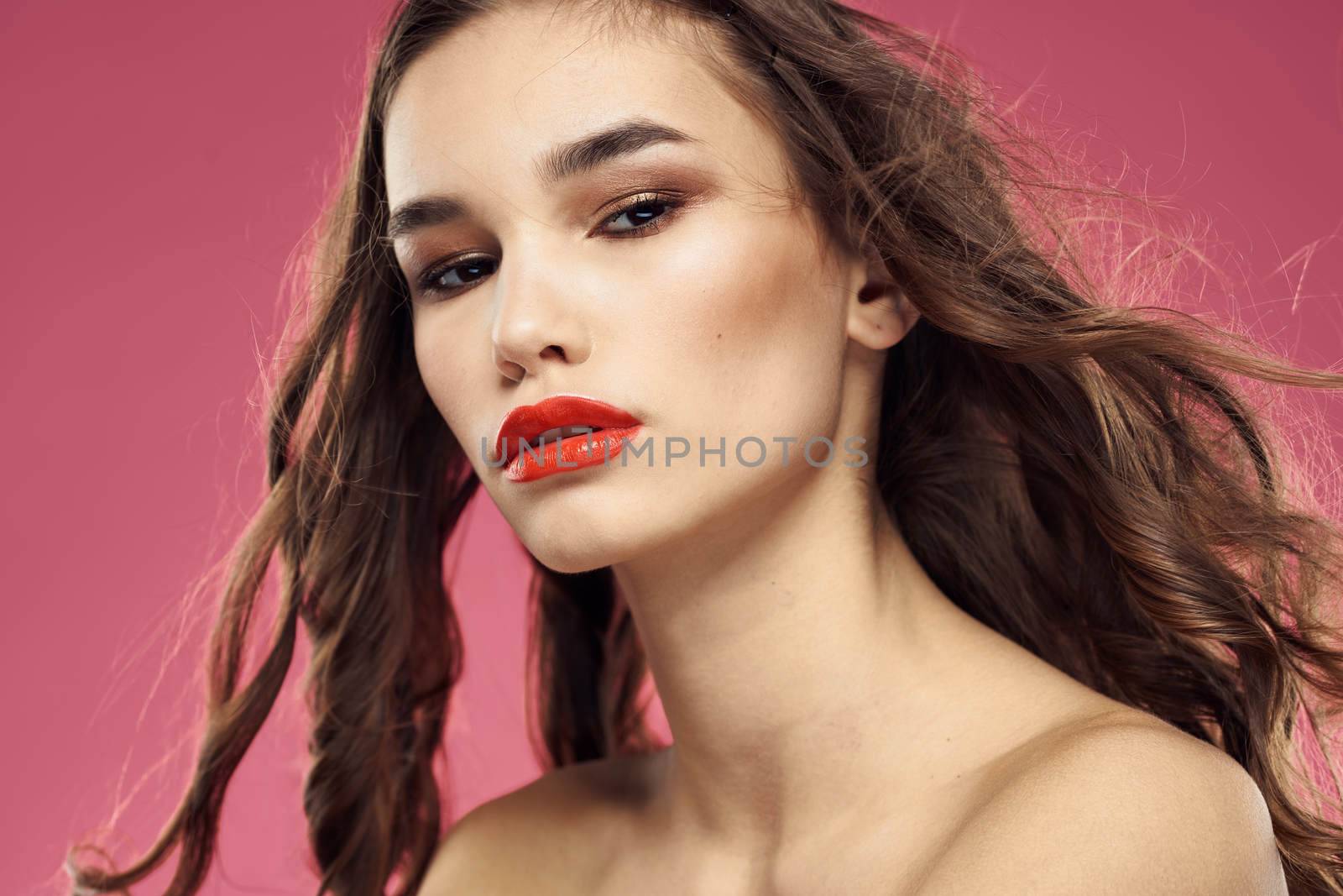 Beautiful woman with red lips on a pink background nude shoulders cropped view by SHOTPRIME