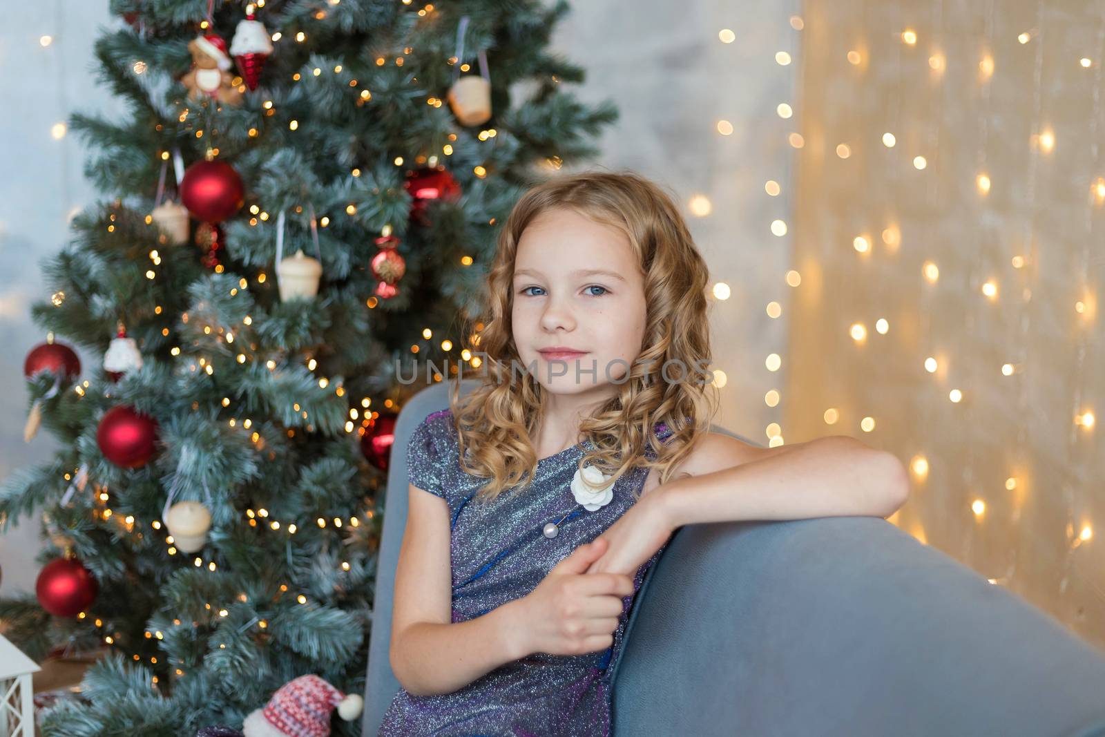 .Portrait of a cute girl on the background of Christmas garlands.