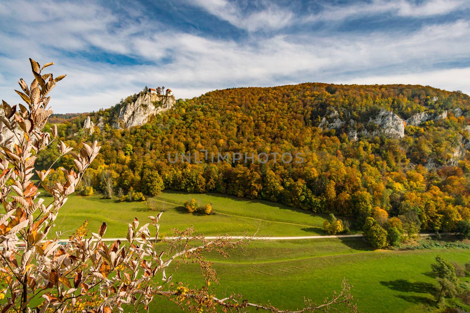 Colorful view of Bronnen Castle on the hiking trail in autumn in the Danube valley near Beuron by mindscapephotos