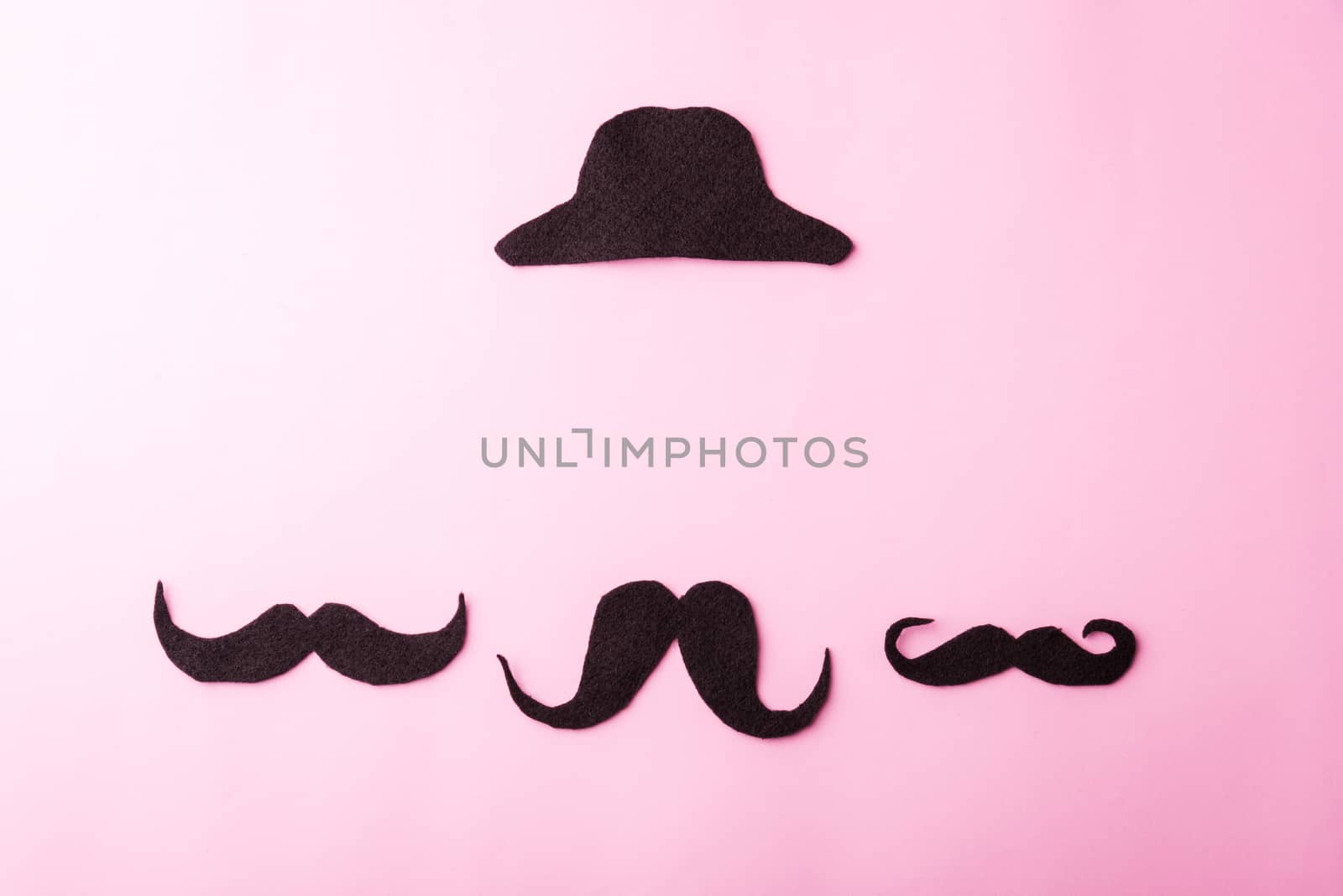 Black mustache and cap, studio shot isolated on pink background, Prostate cancer awareness month, Fathers day, minimal November moustache concept