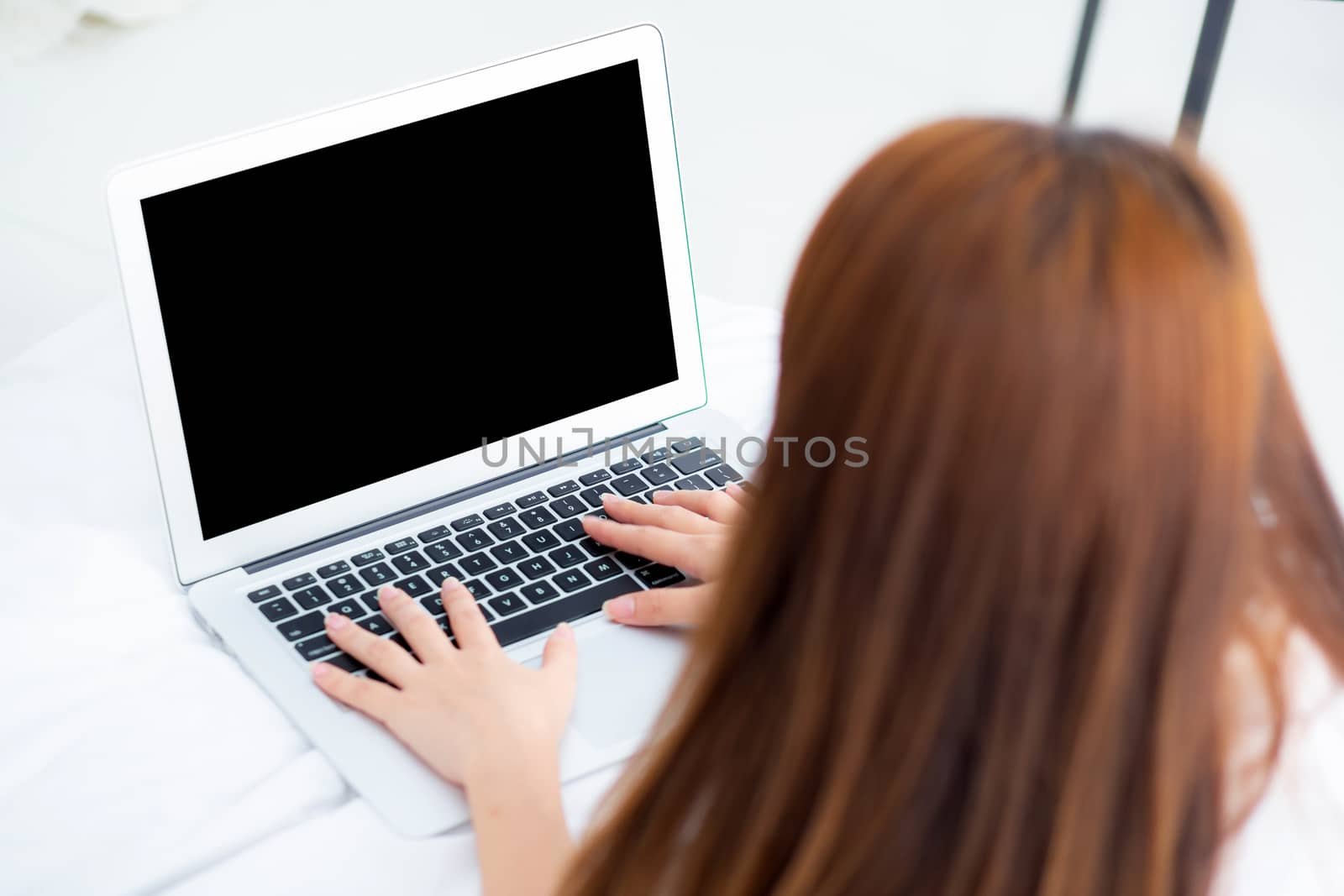 Closeup young asian woman using laptop for leisure on bedroom, g by nnudoo