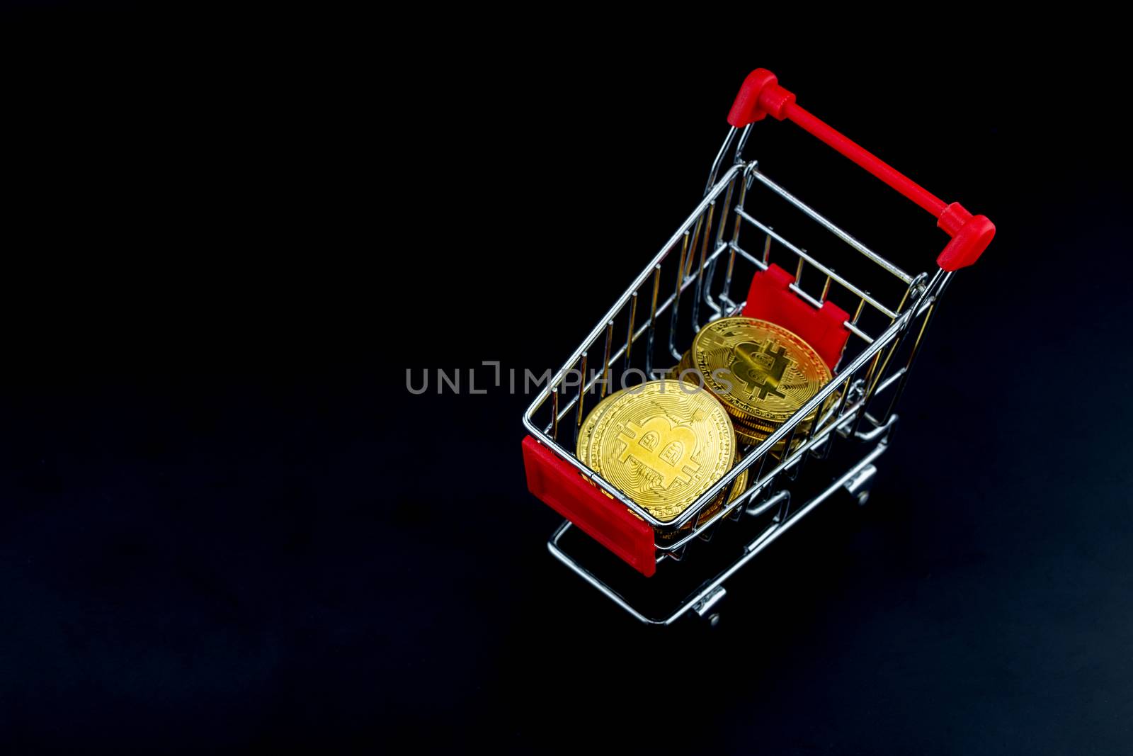 Shopping carts with gold bitcoin isolated on black background, digital currency money trading with cryptocurrency, coin with profit, finance concept, top view.