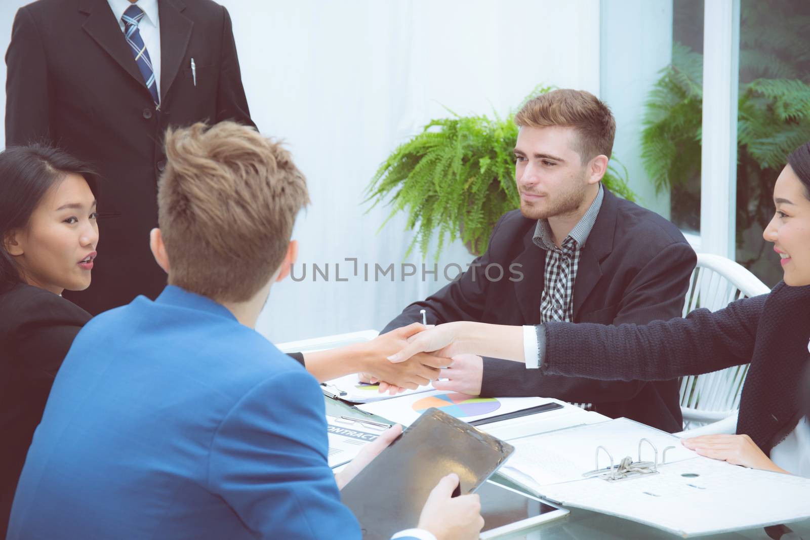 Group of business team people shaking hand with success, agreement of discussion with handshake after meeting  in teamwork, communication concept.