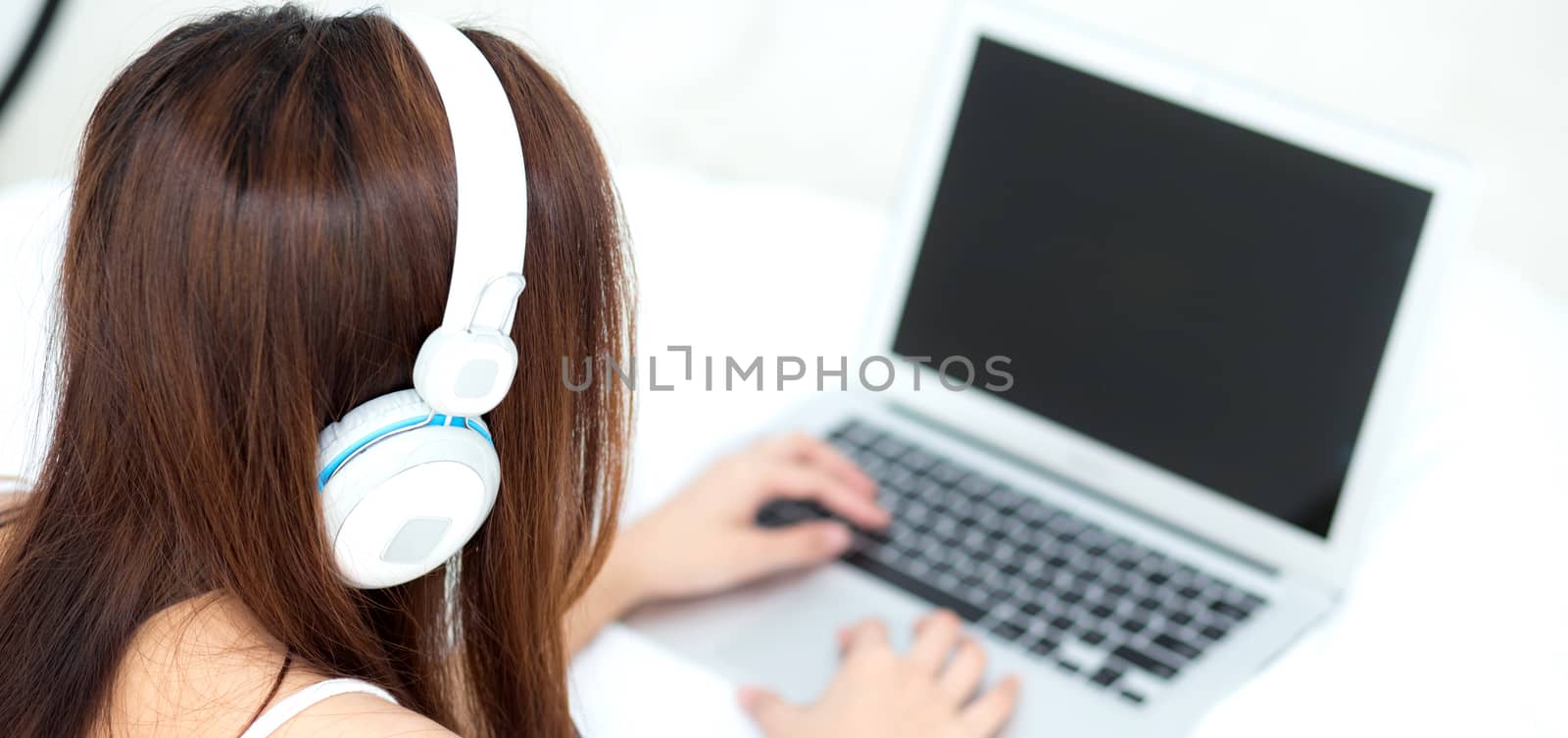 Banner website asian young woman relax listening to music with headphone and laptop online internet on vacation in bedroom, cheerful of asia girl leisure, top view, lifestyle concept.