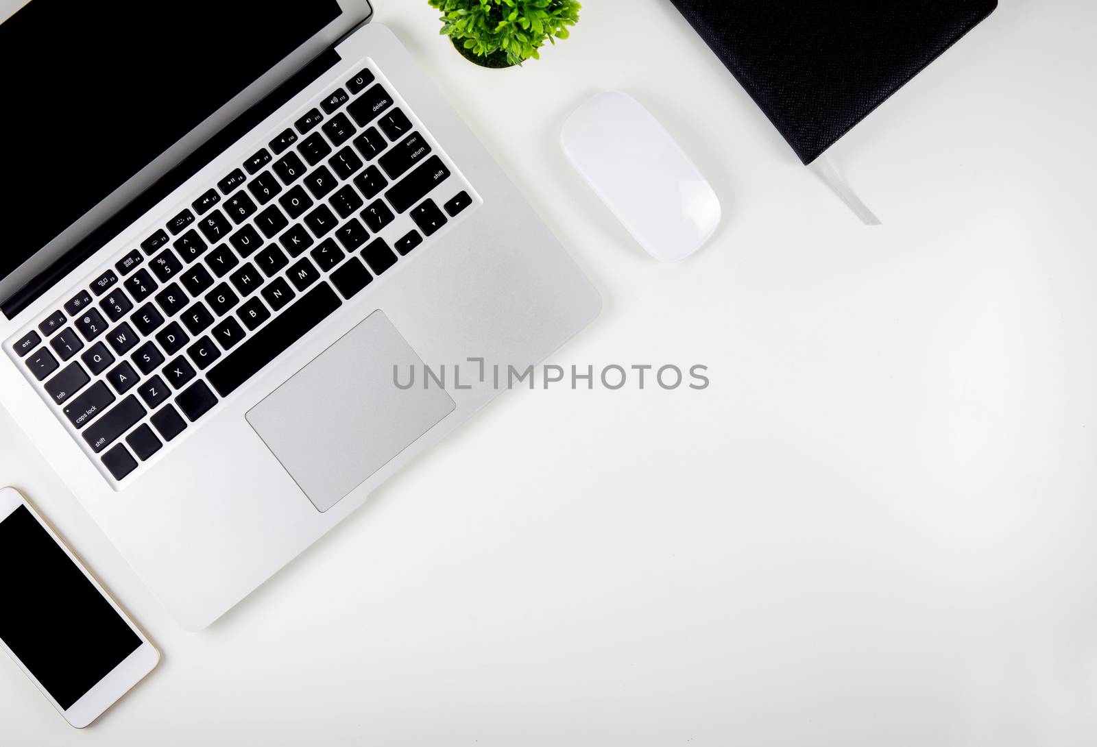 Top view of laptop computer with open display screen monitor, mouse and notepad and book and smart mobile phone isolated on white background, communication technology on work office concept.