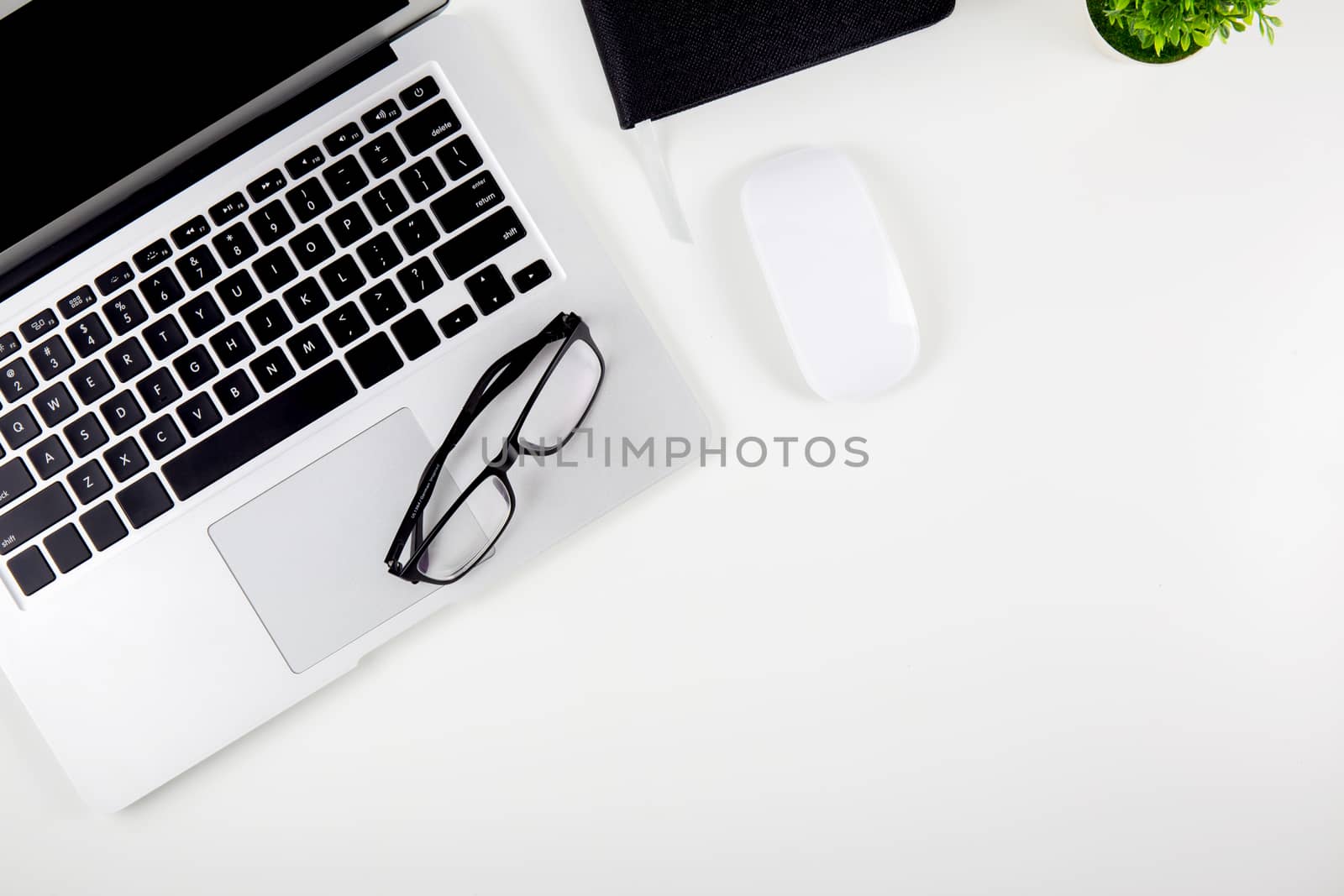 Top view of laptop computer with open display screen monitor, mouse and notepad and glasses isolated on white background, notebook or netbook with keyboard work on desk office, communication technology concept.