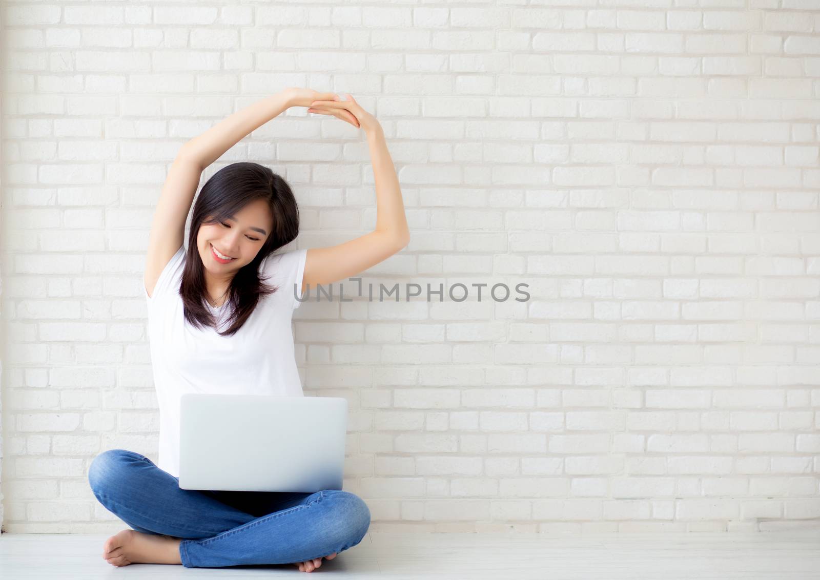 Beautiful portrait young asian woman sitting with laptop stretch by nnudoo