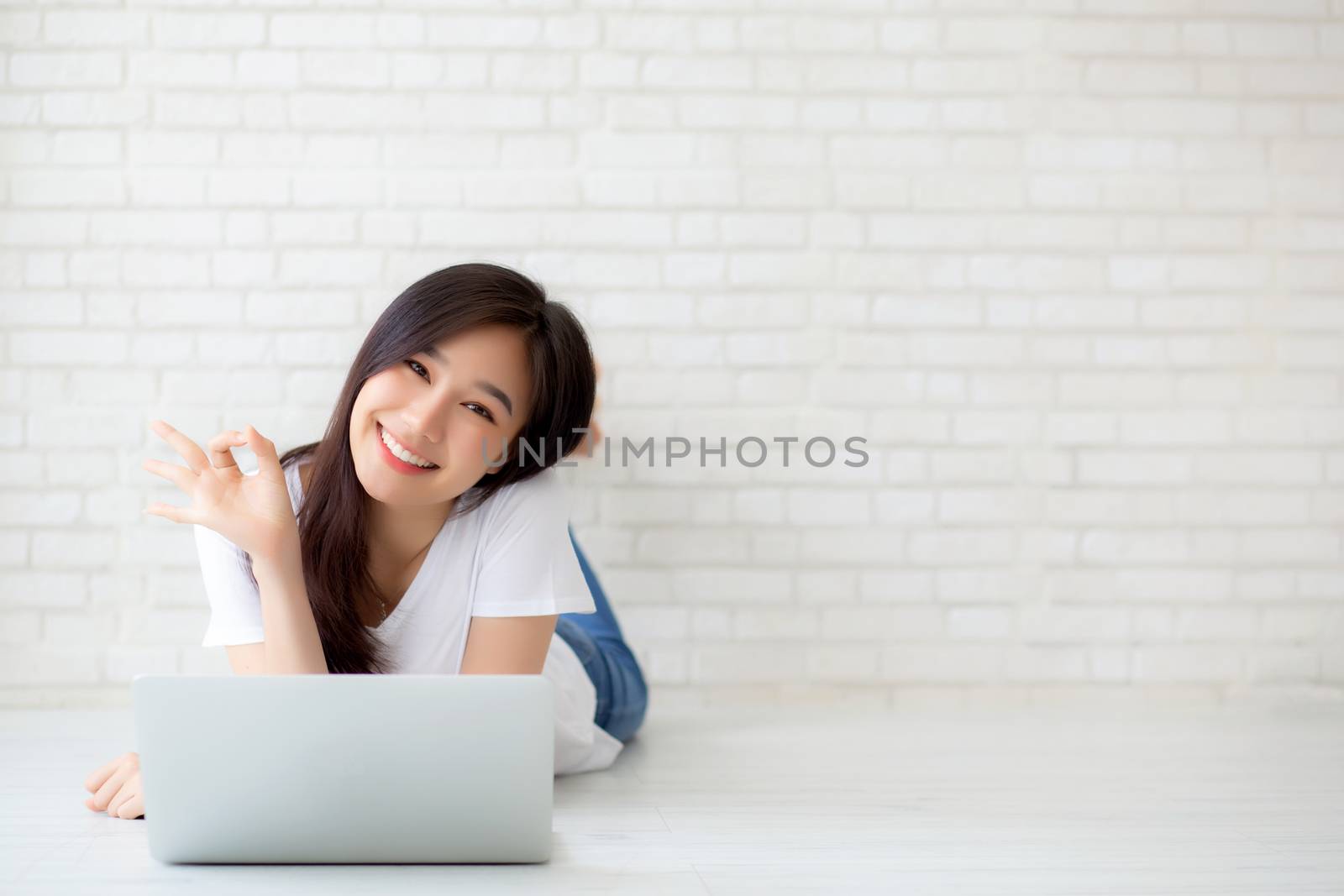 Beautiful portrait asian young woman working online laptop with  by nnudoo