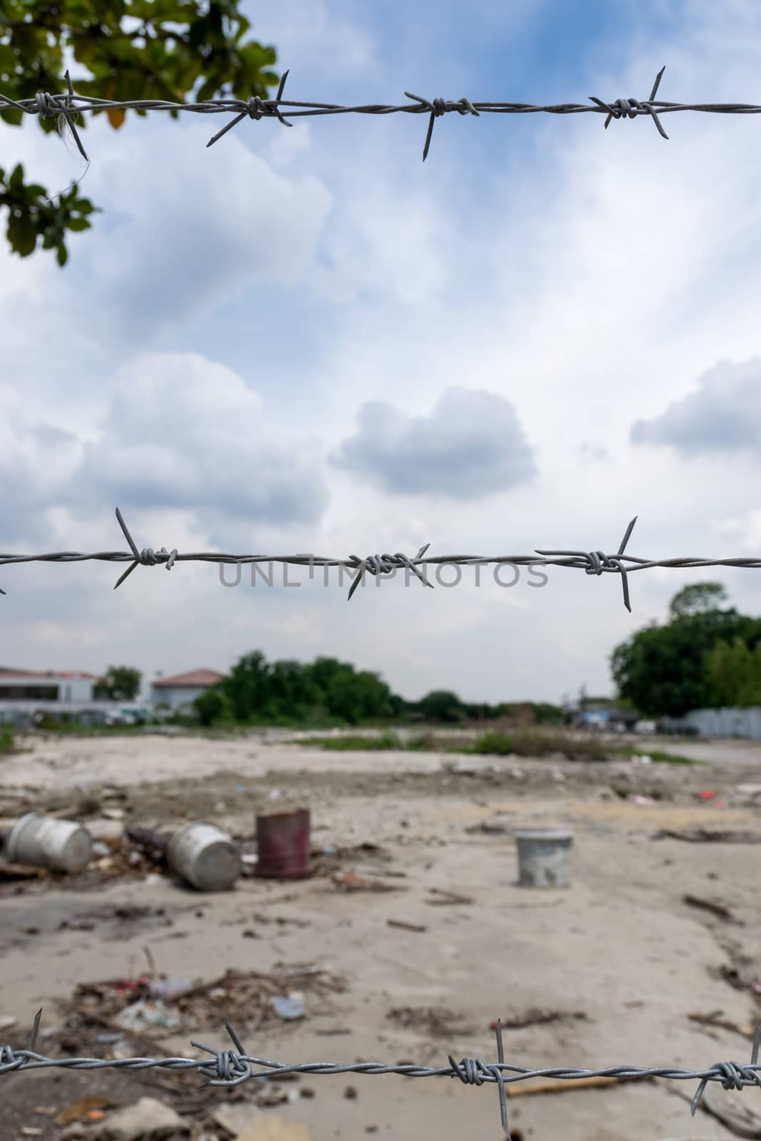 wire with clusters of short, sharp spikes set at intervals along it, used to make fences or in warfare as an obstruction.