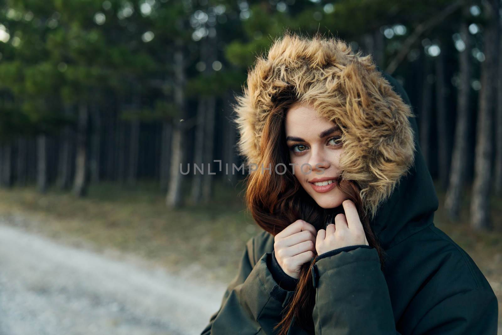Pretty woman warm hooded jacket on nature close-up attractive look by SHOTPRIME