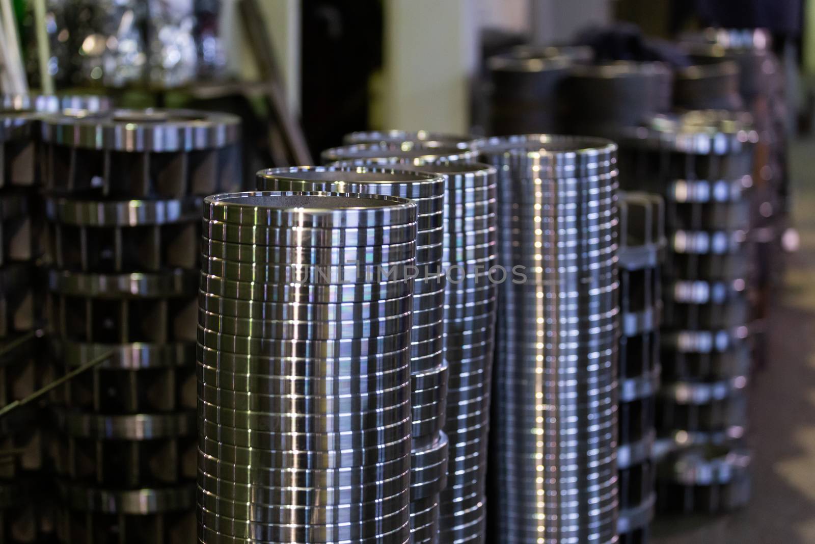 stacks of turned silver colored steel rings after cnc turning operations - close-up with selective focus technique