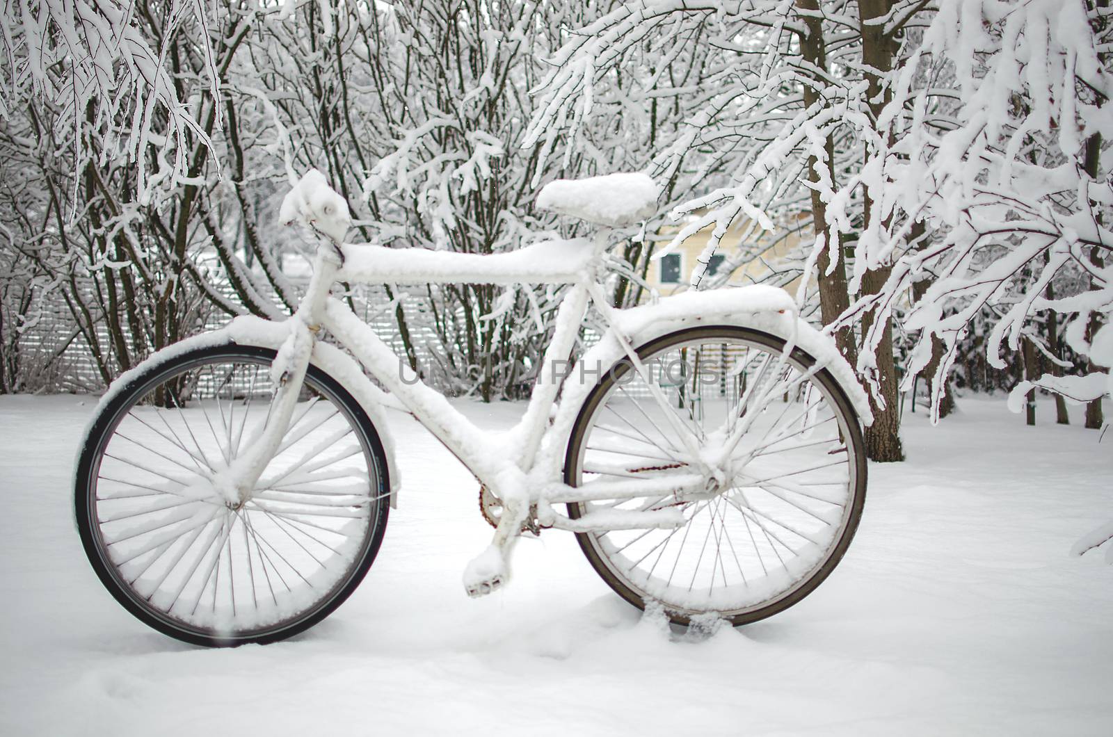 Abandoned bike or bicycle with snow cover in winter. Bike buried in snow. Snowstorm forecast. Winter in the city