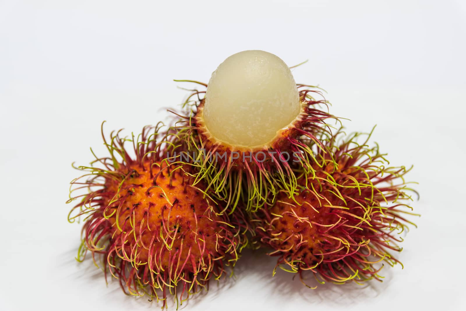 Rambutan thai fruits a red, plum-sized tropical fruit with soft spines and a slightly acidic taste.