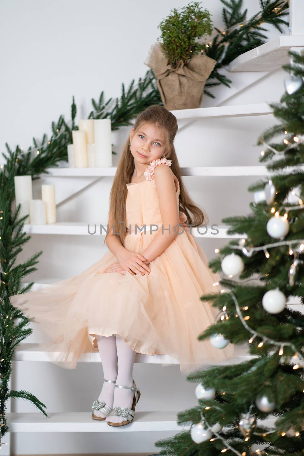Little girl in princess dress celebrates christmas. Christmas magic fairy tale. Happy childhood.
