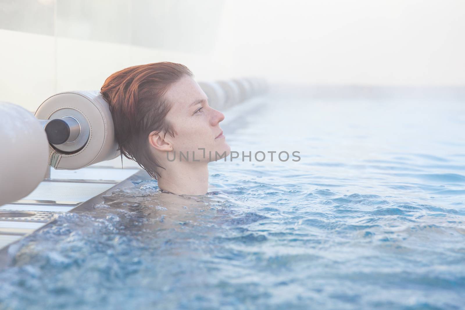 winter pool with a young attractive relaxing woman by Edophoto