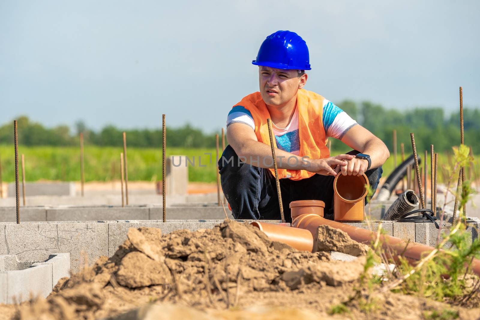 laying plastic pipes to the foundation of the building by Edophoto