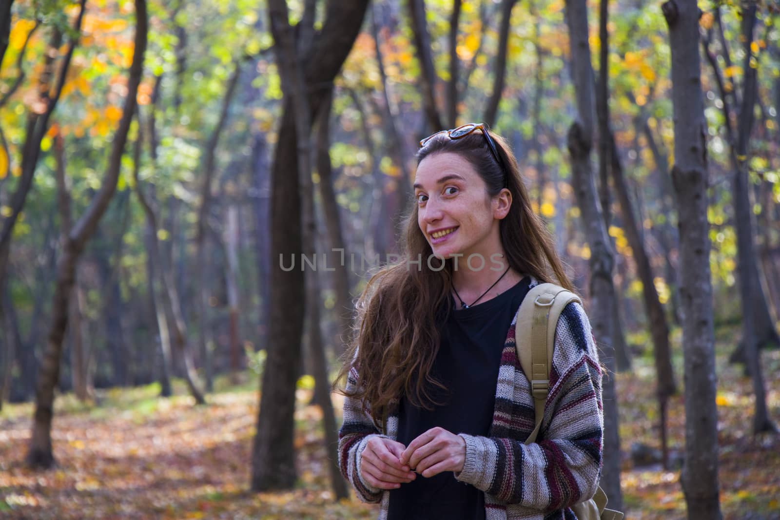 Beautiful woman in autumn and fall forest and wild, autumn tree with yellow and red leaves in Tbilisi, Georgia