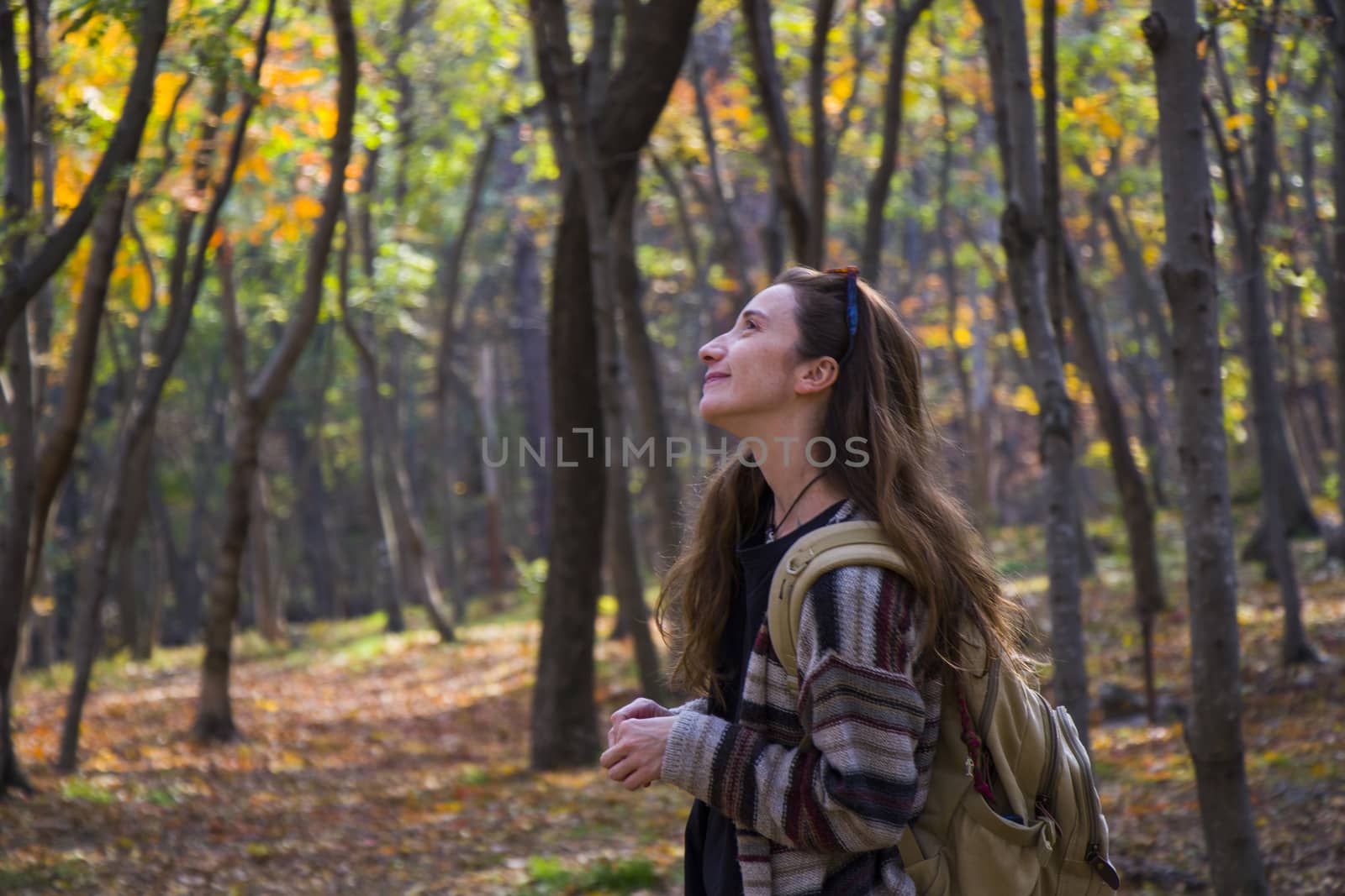 Beautiful woman in autumn and fall forest and wild, autumn tree with yellow and red leaves in Tbilisi, Georgia