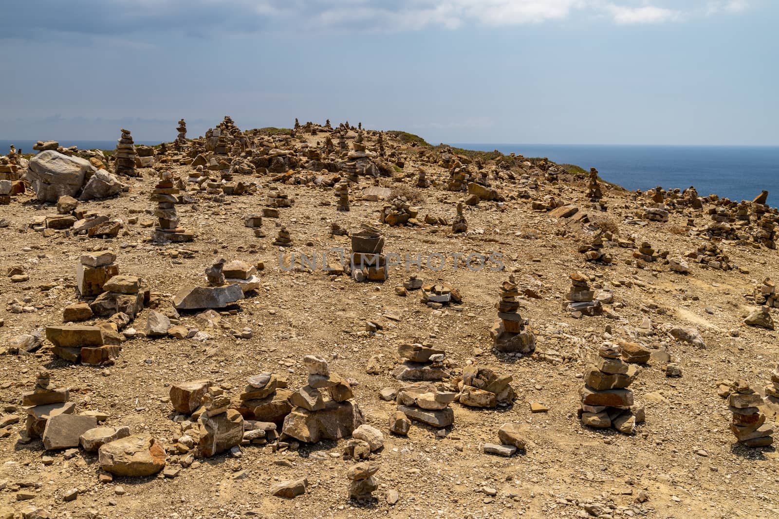 Many stacked stones on a hill at peninsula Prasonisi on Rhodes i by reinerc