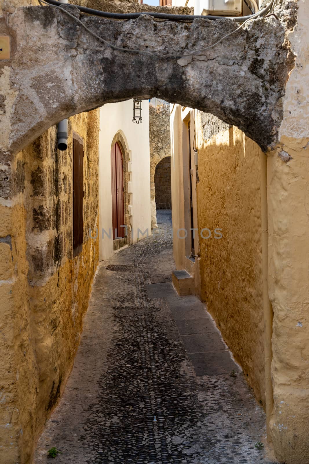 Narrow alley / lane in the old town of Rhodes city  by reinerc