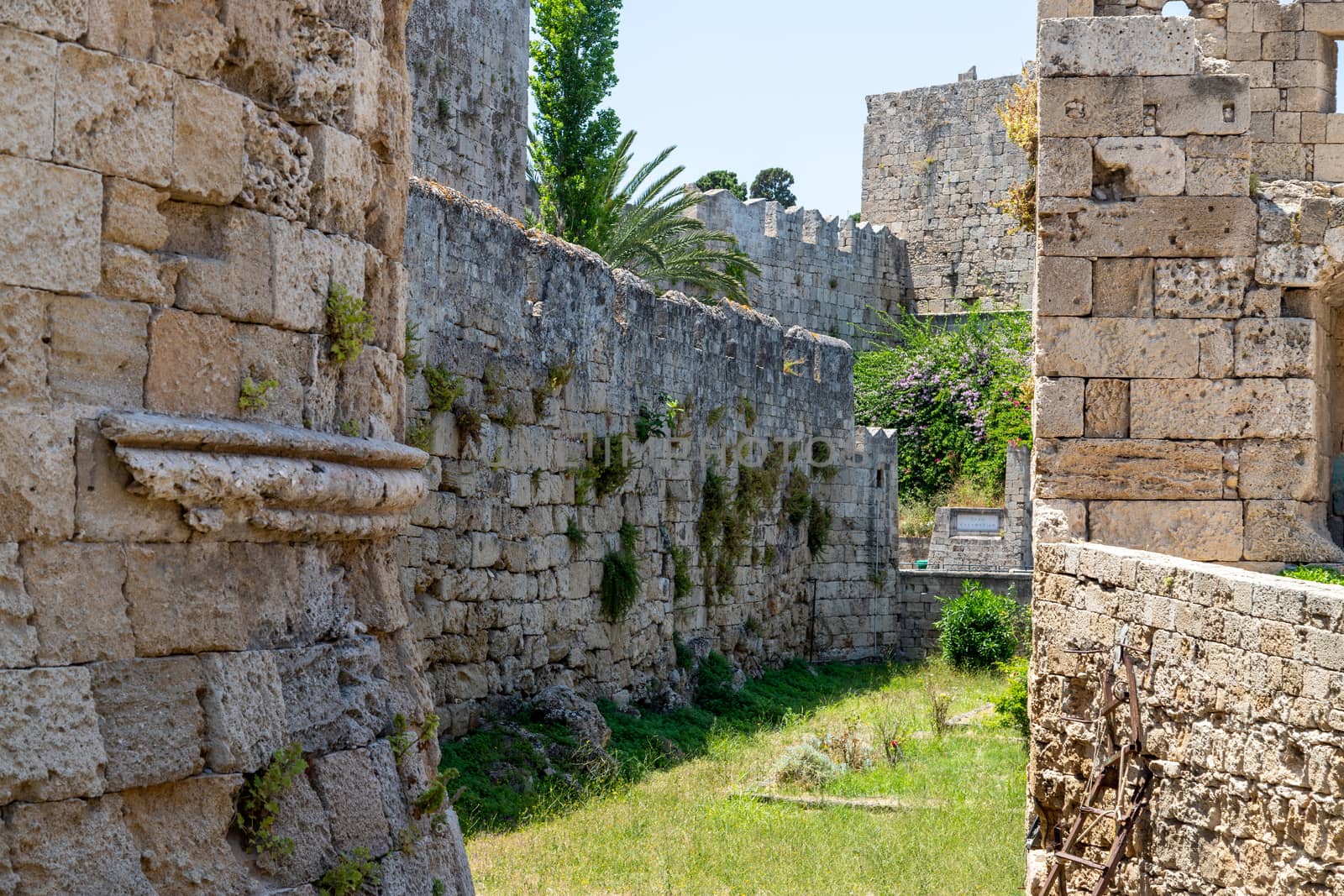 Part of the antique city wall with ditch in the old town of Rhodes city on Greek island Rhodes