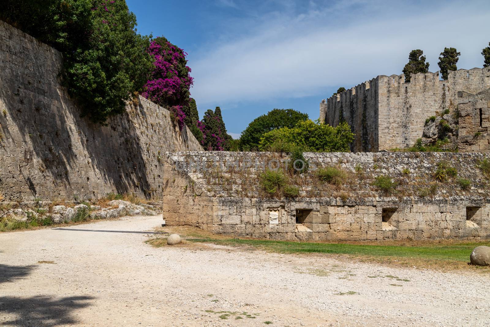 Along the ditch of the antique city wall in the old town of Rhodes city at greek island Rhodes on a sunny day in summer