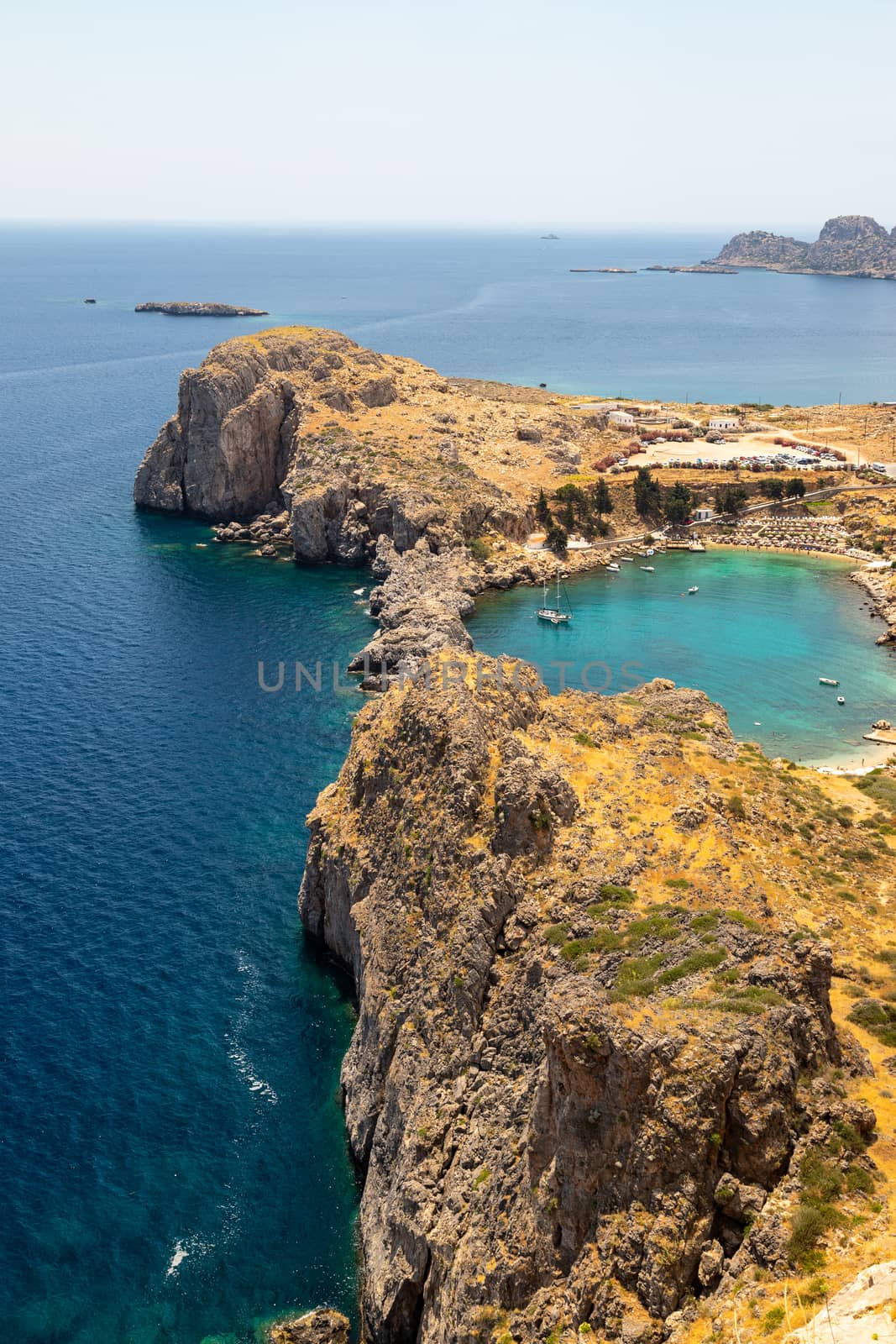 Scenic view from the acropolis of Lindos at the coastline of the by reinerc