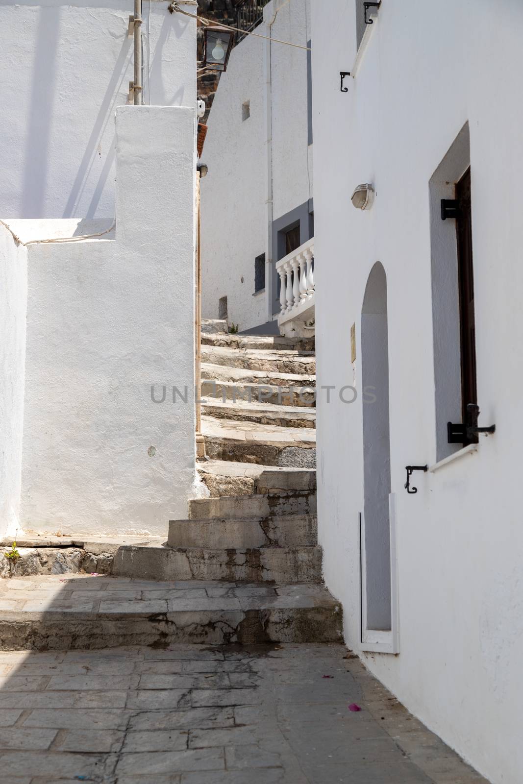 Narrow lane with stairs and white houses in Lindos on Greek isla by reinerc