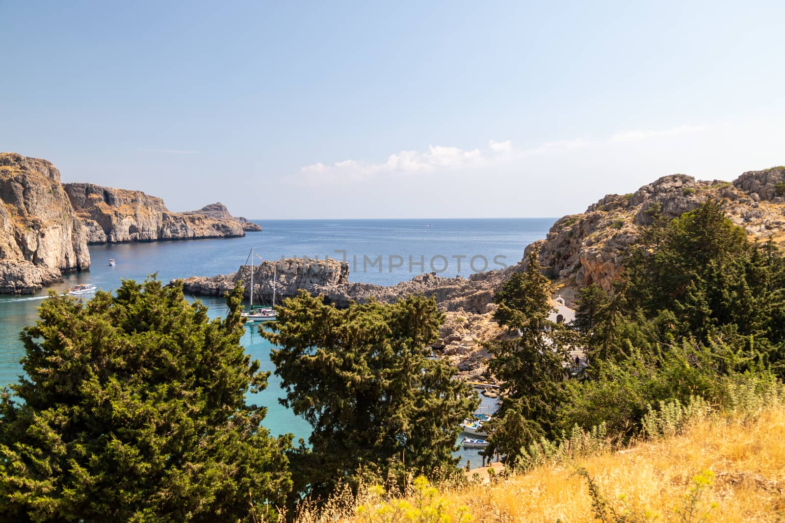 Scenic view at St. Pauls bay in Lindos on Rhodes island, Greece on a sunny day 