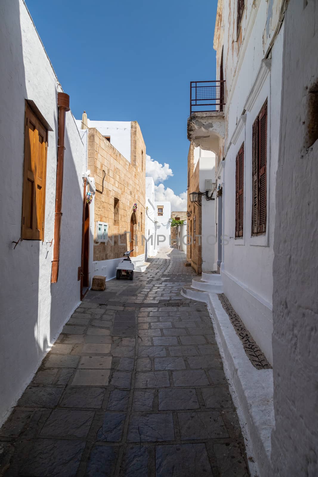 Narrow lane with white houses in Lindos on Greek island Rhodes by reinerc